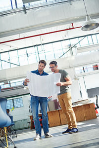 Colleagues reviewing business plan at office