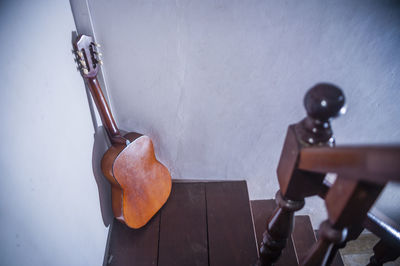 High angle view of acoustic guitar on staircase at home