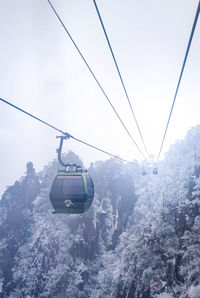 Overhead cable car over snowcapped mountains