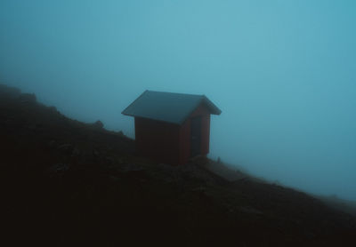 Building on mountain against sky