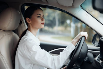 Portrait of doctor sitting in car