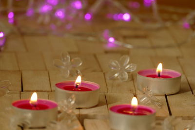 Close-up of lit candles on table