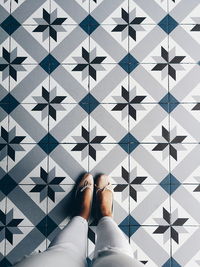 Low section of woman standing on tiled floor