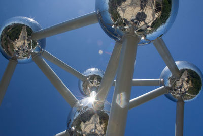 Low angle view of illuminated lamp against blue sky