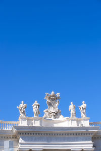 Low angle view of statue against blue sky