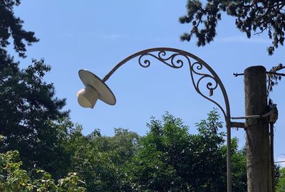 Low angle view of sign board against sky