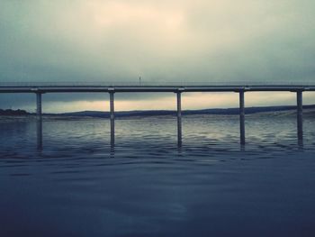 Bridge over sea against sky