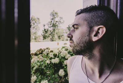 Man looking through house window