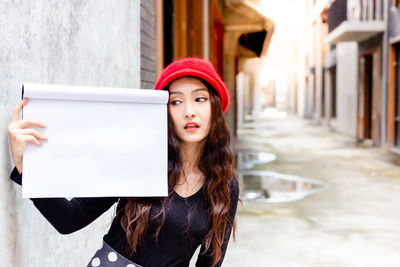 Portrait of young woman wearing hat