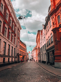 Street amidst buildings in city against sky