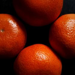 Close-up of oranges over black background