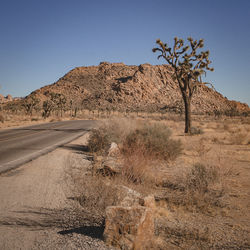 Scenic view of desert against clear blue sky