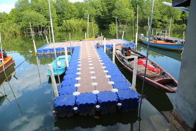 Boats moored in the  river against trees