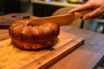 Close-up of person preparing food on cutting board