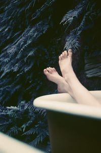 Low section of woman resting in water