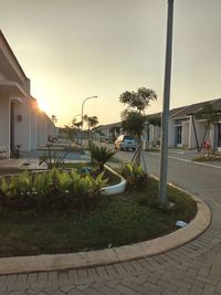 Footpath by swimming pool against buildings in city