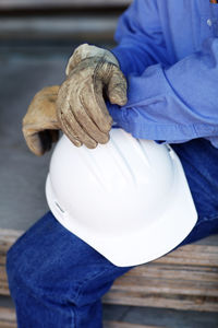 Close up of a male construction foreman holding a hard hat