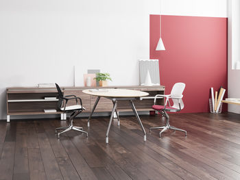 Empty chairs and tables on hardwood floor at home