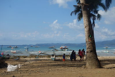 People on beach against sky