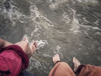 Low section of people in flowing river