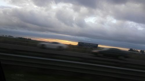 Cloudy sky above road at sunset