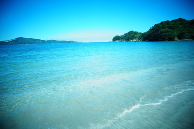 Scenic view of sea against clear blue sky