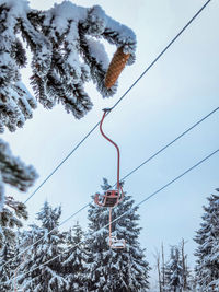 Low angle view of ski lift against sky