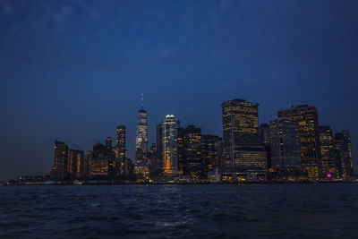 Illuminated city at waterfront