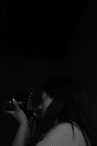 Portrait of woman holding smart phone at night