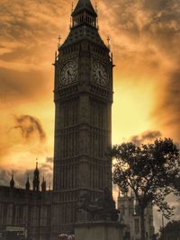 Low angle view of clock tower against sky during sunset