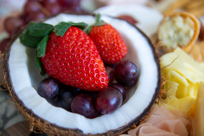 Close-up of grapes and strawberries in coconut
