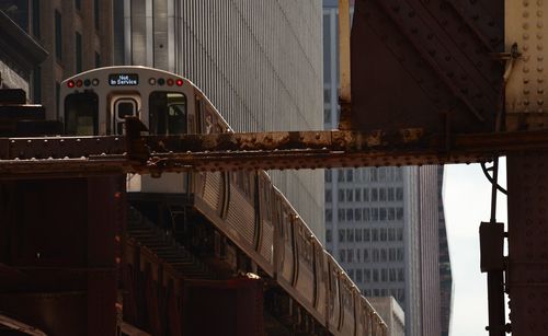 Low angle view of train on bridge in city