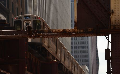 Low angle view of bridge amidst buildings in city