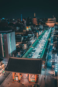 High angle view of illuminated buildings in city at night