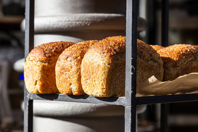 Fresh baked artisan bread on a shelf in bakery shop. gourmet breads for sale.