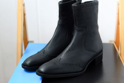 Close-up of black boots on table at home