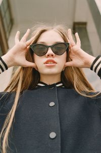 Portrait of young woman wearing sunglasses