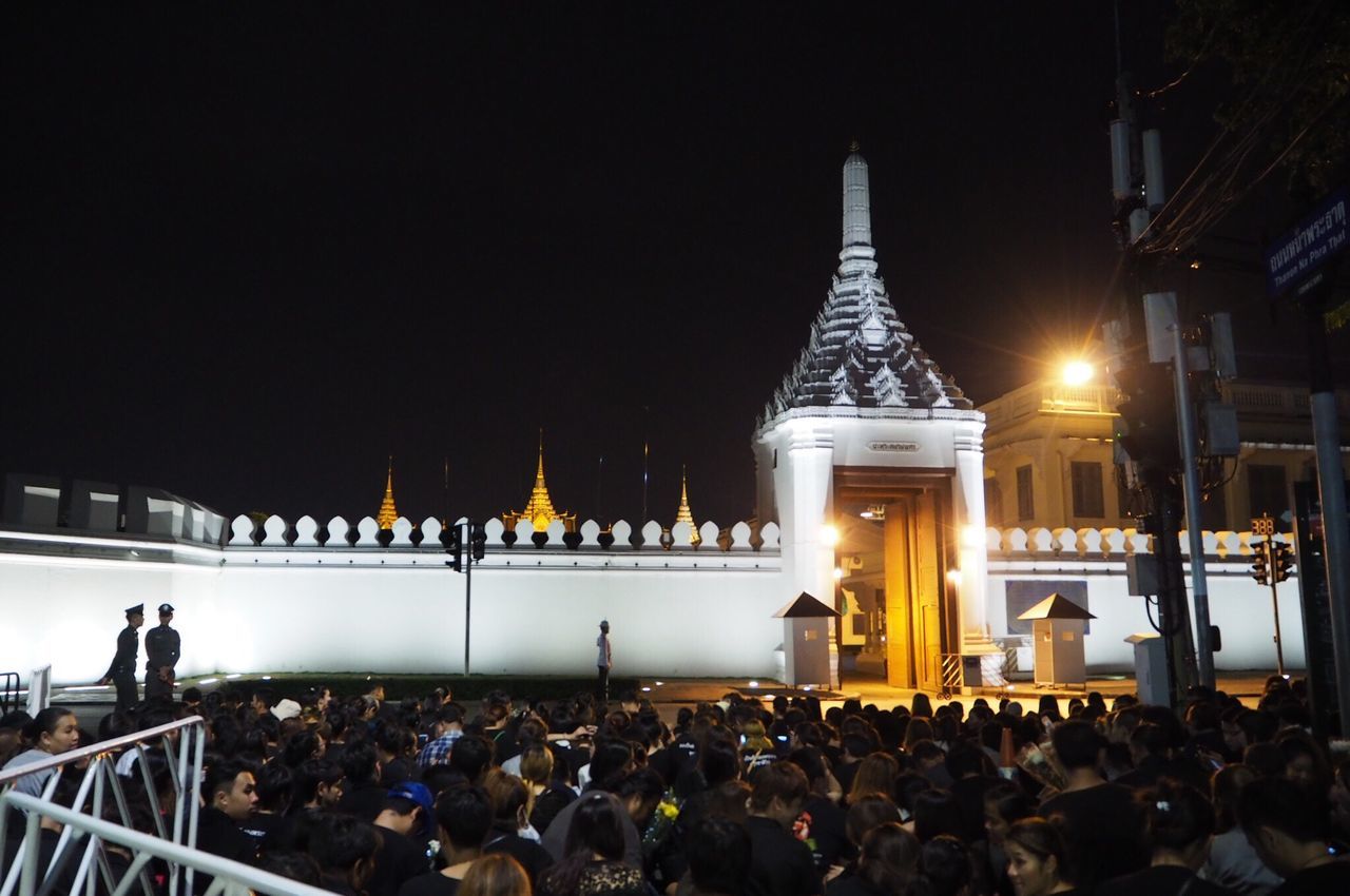 illuminated, large group of people, night, tourism, travel destinations, person, famous place, international landmark, togetherness, crowd, vacations, capital cities, memories, performance, sky, weekend activities, in front of