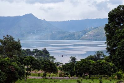 Scenic view of lake and mountains against sky