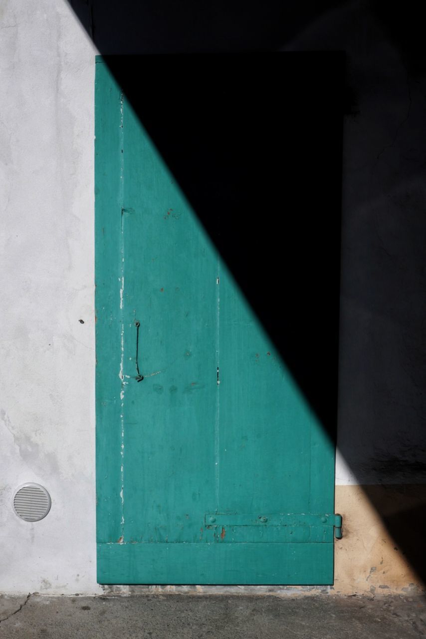 architecture, green color, door, built structure, entrance, no people, wall - building feature, day, outdoors, security, protection, safety, closed, building exterior, wood - material, metal, nature, building, sunlight, old, turquoise colored, garage