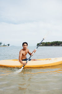 Man kayaking in sea