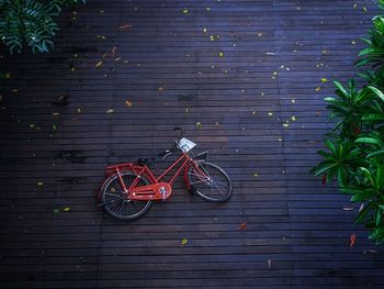 High angle view of bicycle on footpath against brick wall