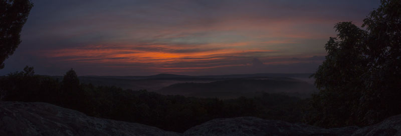 Scenic view of mountains against sky at sunset