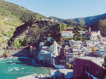 High angle view of buildings and mountains against clear sky