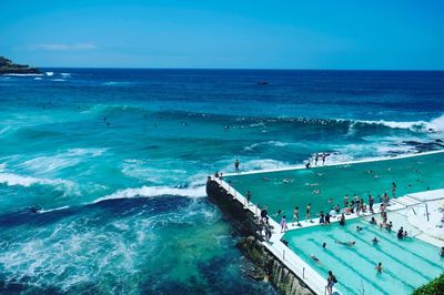 High angle view of people swimming in sea