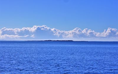 Scenic view of sea against blue sky