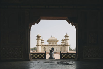 Rear view of woman standing on archway of historical building