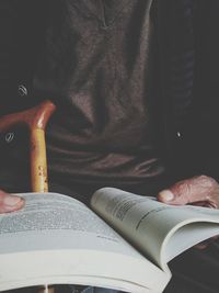 Close-up of man reading book