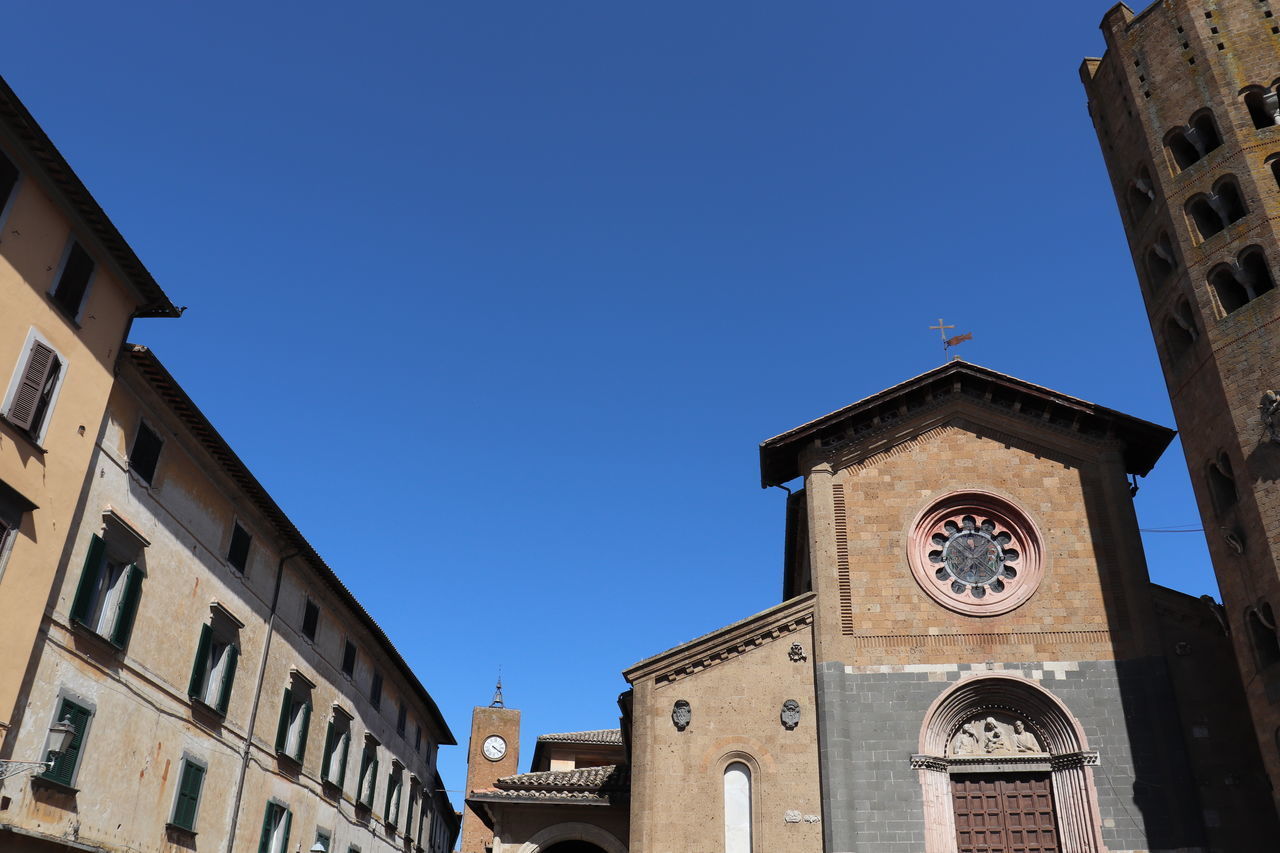 LOW ANGLE VIEW OF BUILDINGS AGAINST BLUE SKY