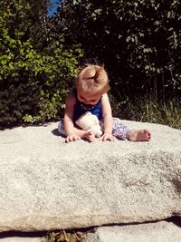 Full length of cute girl sitting outdoors